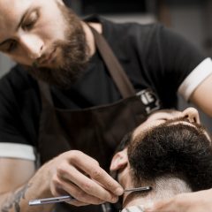 barber-shaving-customer-s-beard-with-razor