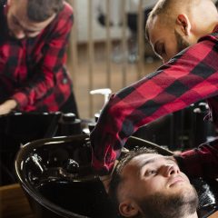 young-hairdresser-washing-mans-hair